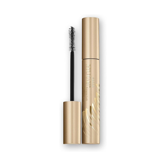 Gold mascara with black brush on a white background